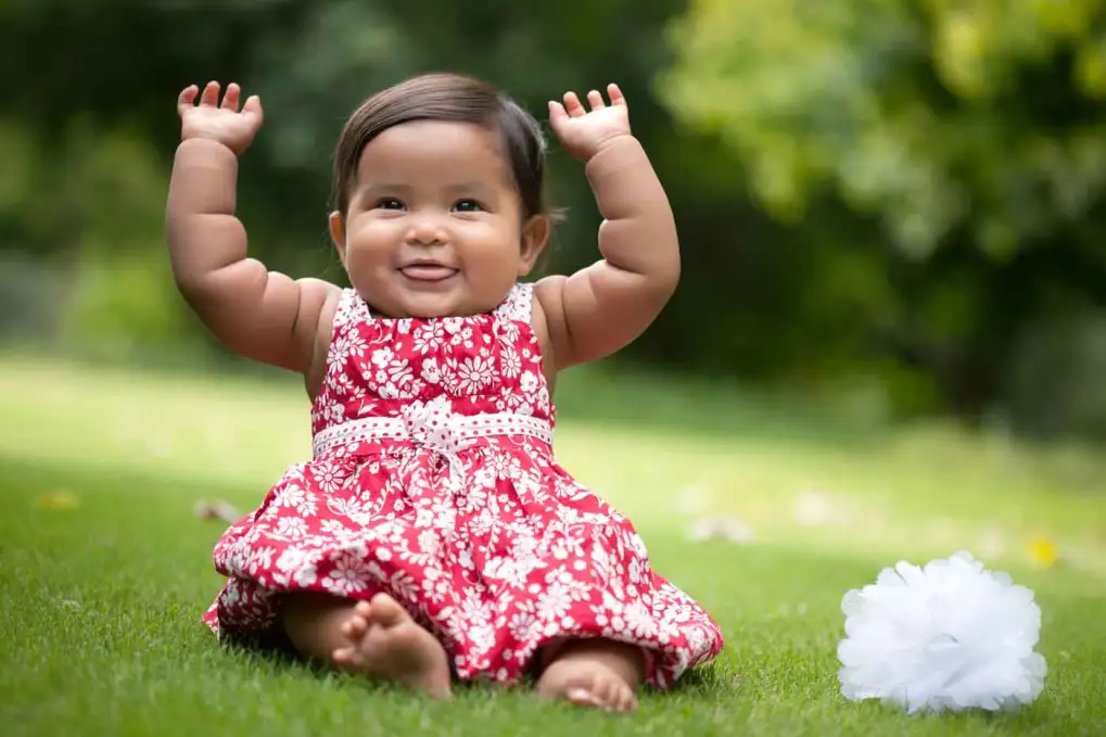 Cute baby laying on grass.