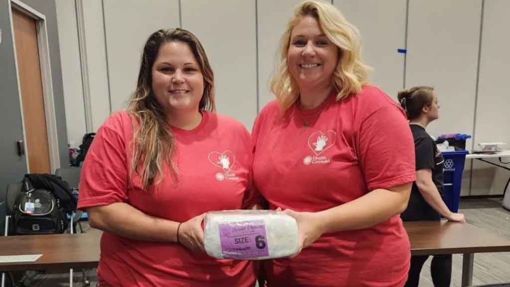 Volunteers showing diapers their group wrapped.