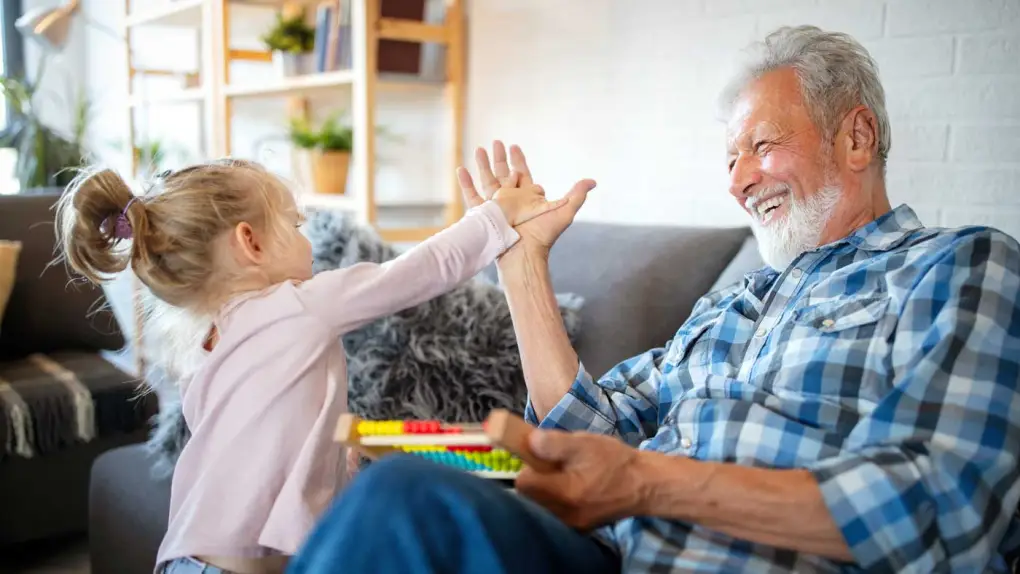 Grand daughter high-fiving her grandpa.