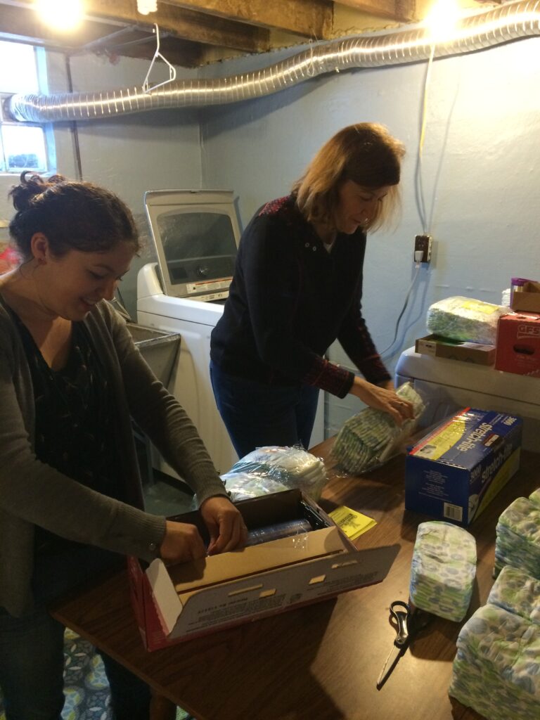Volunteers wrap diapers in our founder basement 10 years ago!